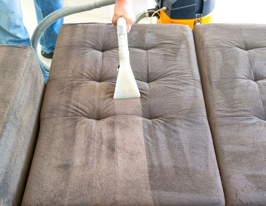 vacuuming a futon sofa
